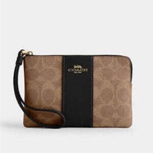 COACH Corner Zip Wristlet In Signature Tan Canvas With Black Leather Stripe